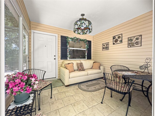 2102 Estevez Dr, Lady Lake, FL 32159 - living area with wood walls and plenty of natural light