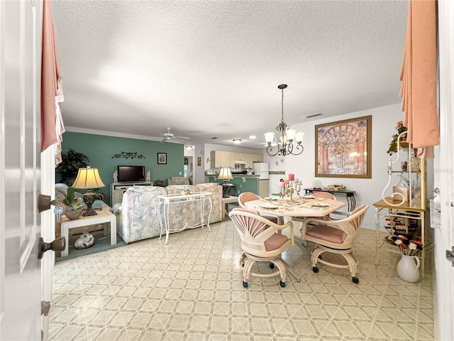 2102 Estevez Dr, Lady Lake, FL 32159 - dining room featuring a ceiling fan, a chandelier, and a textured ceiling