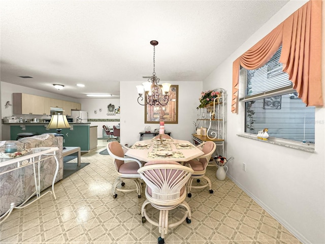 2102 Estevez Dr, Lady Lake, FL 32159 - dining room with a chandelier, light flooring, baseboards, and a textured ceiling
