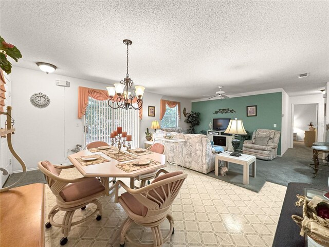 2102 Estevez Dr, Lady Lake, FL 32159 - dining room featuring a chandelier, light carpet, a ceiling fan, and a textured ceiling