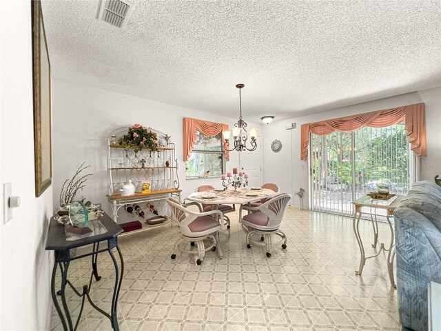 2102 Estevez Dr, Lady Lake, FL 32159 - dining area with a chandelier, a textured ceiling, and light flooring