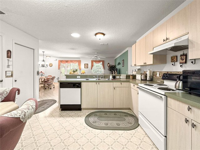 2102 Estevez Dr, Lady Lake, FL 32159 - kitchen with white appliances, under cabinet range hood, a peninsula, a sink, and light flooring