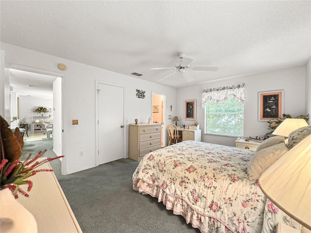 2102 Estevez Dr, Lady Lake, FL 32159 - bedroom featuring a textured ceiling, dark colored carpet, and a ceiling fan