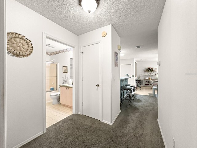 2102 Estevez Dr, Lady Lake, FL 32159 - corridor with carpet floors, a textured ceiling, and baseboards