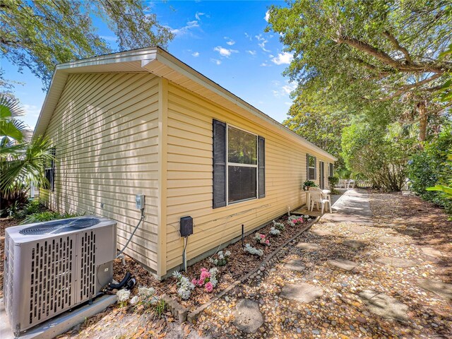 2102 Estevez Dr, Lady Lake, FL 32159 - view of side of property featuring central AC unit