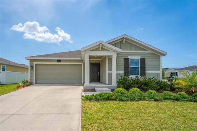 5354 Travertine St, Mount Dora, FL 32757 - view of front of home featuring fence, an attached garage, board and batten siding, a front yard, and driveway