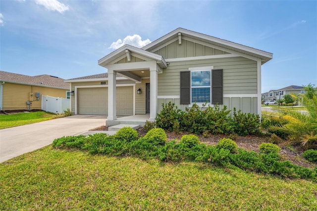 5354 Travertine St, Mount Dora, FL 32757 - view of front of property featuring board and batten siding, driveway, a front lawn, and a garage