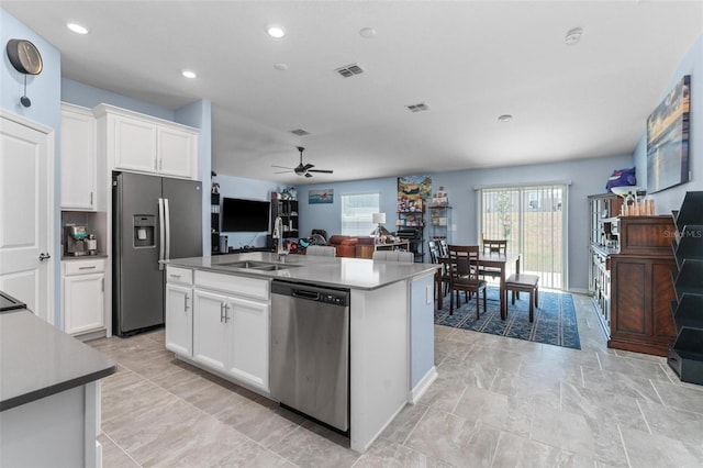 5354 Travertine St, Mount Dora, FL 32757 - kitchen with stainless steel appliances, a ceiling fan, white cabinetry, open floor plan, and visible vents