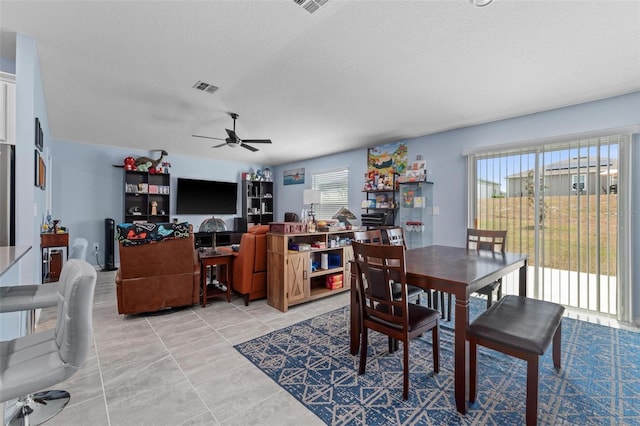 5354 Travertine St, Mount Dora, FL 32757 - dining area with visible vents, a textured ceiling, ceiling fan, and light tile patterned flooring
