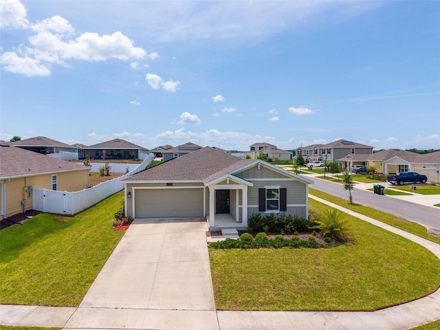 5354 Travertine St, Mount Dora, FL 32757 - view of front of home with a residential view, fence, a garage, a front yard, and driveway
