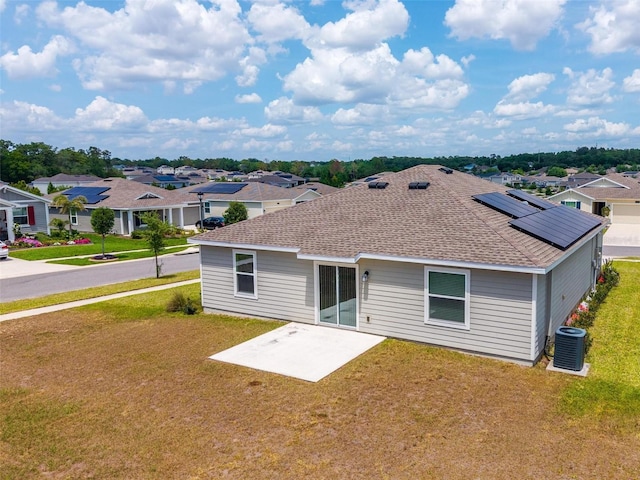 5354 Travertine St, Mount Dora, FL 32757 - rear view of property featuring roof with shingles, a patio area, central air condition unit, a yard, and a residential view