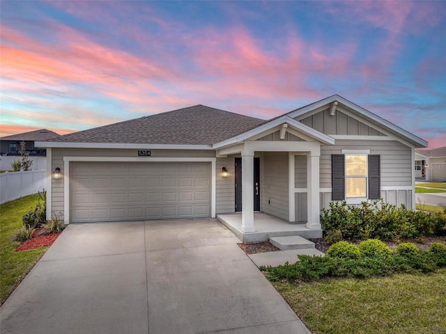 5354 Travertine St, Mount Dora, FL 32757 - ranch-style home featuring a garage, a porch, board and batten siding, and driveway