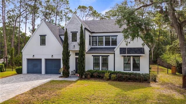 modern farmhouse featuring fence, stucco siding, and roof with shingles