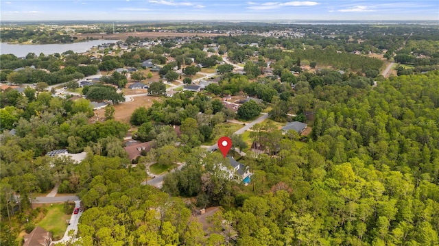 bird's eye view with a water view and a wooded view