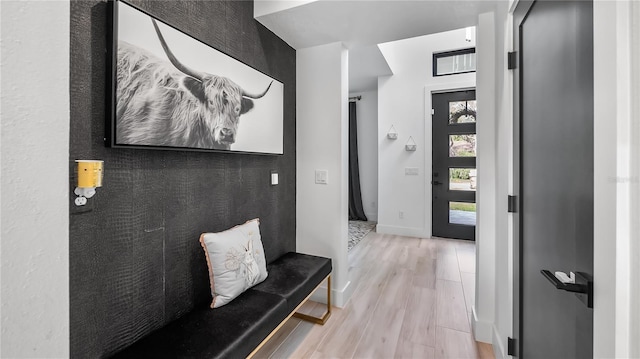 entryway with baseboards and light wood-style flooring