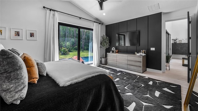 bedroom with ceiling fan, access to exterior, visible vents, light wood-type flooring, and lofted ceiling