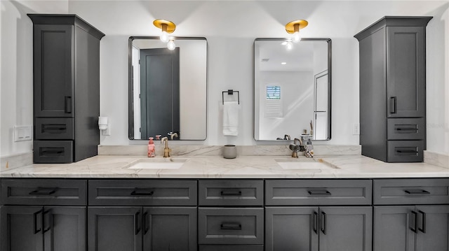 full bathroom with a sink and double vanity