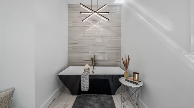 full bath featuring baseboards and a freestanding bath