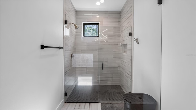 full bathroom with baseboards and a stall shower