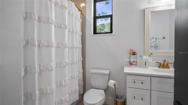 bathroom featuring toilet, a shower with curtain, and vanity