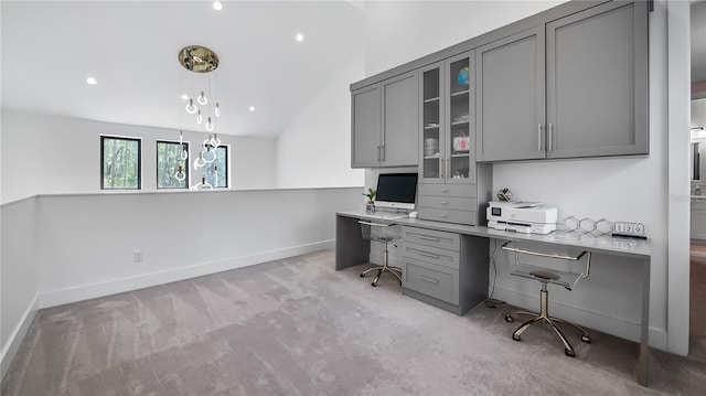 office featuring light colored carpet, built in study area, baseboards, lofted ceiling, and recessed lighting