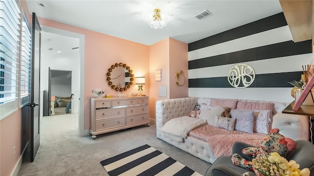bedroom with visible vents and carpet