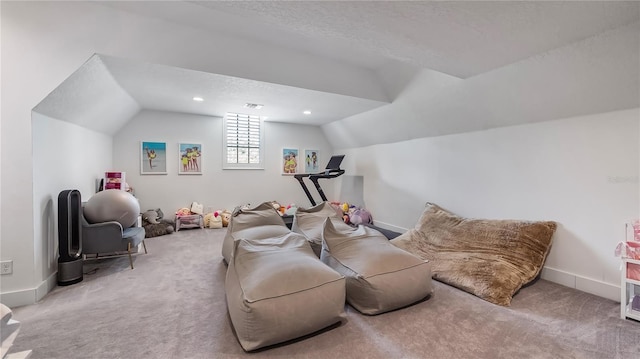 interior space featuring a textured ceiling, visible vents, baseboards, lofted ceiling, and carpet