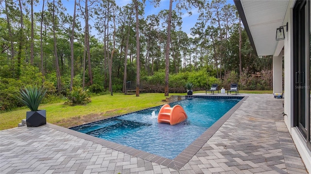 pool featuring a patio and a yard