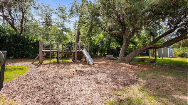 view of jungle gym featuring an outbuilding and a shed