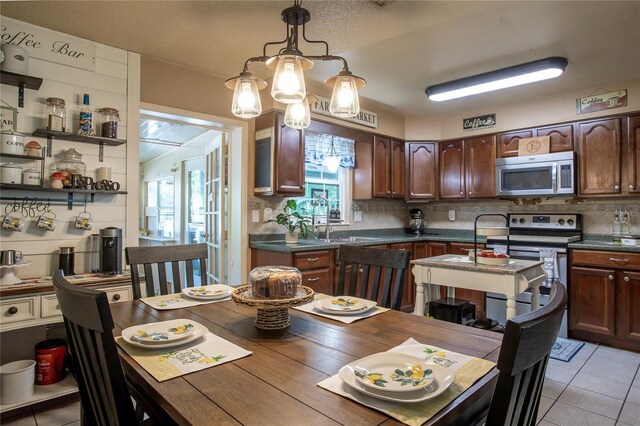 616 Third Ave, Lady Lake, FL 32159 - kitchen featuring plenty of natural light, dark countertops, decorative backsplash, and stainless steel appliances