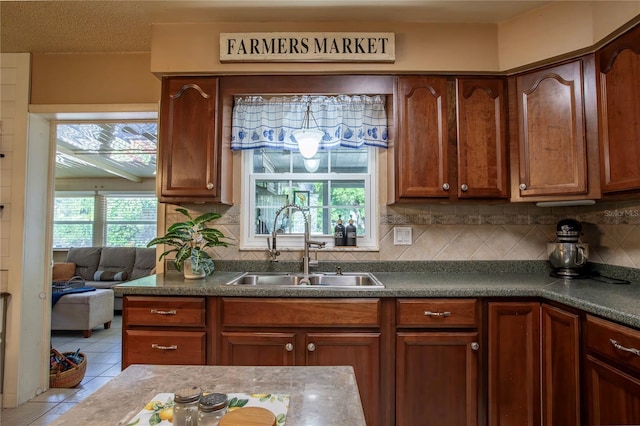 616 Third Ave, Lady Lake, FL 32159 - kitchen featuring a sink, tile patterned floors, tasteful backsplash, and dark countertops