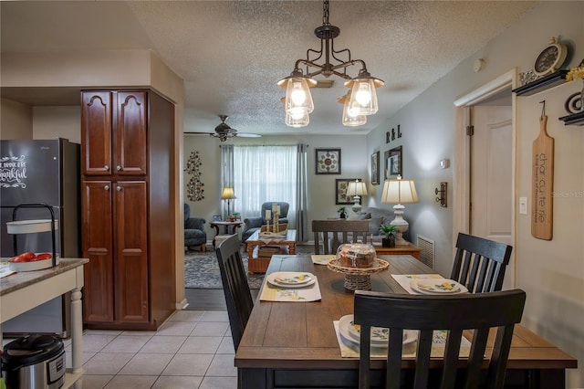616 Third Ave, Lady Lake, FL 32159 - dining room featuring visible vents, a textured ceiling, ceiling fan with notable chandelier, and light tile patterned flooring