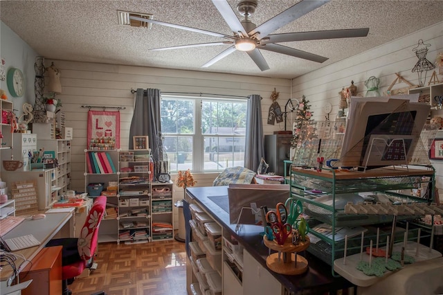 616 Third Ave, Lady Lake, FL 32159 - home office featuring wooden walls, a ceiling fan, a textured ceiling, and visible vents