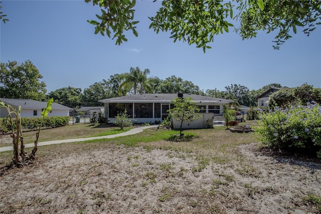 616 Third Ave, Lady Lake, FL 32159 - back of property with a sunroom, a lawn, and fence