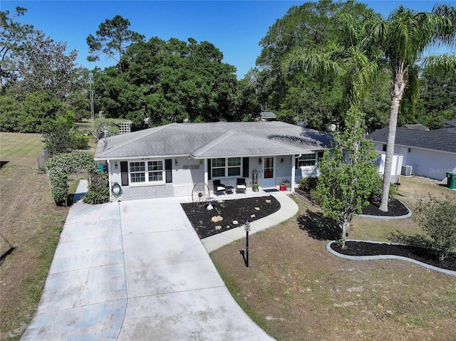 616 Third Ave, Lady Lake, FL 32159 - ranch-style house featuring a front yard, roof with shingles, covered porch, and driveway