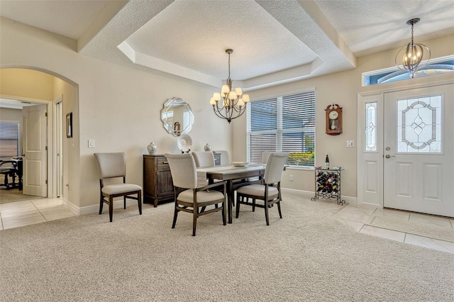 dining area featuring light tile patterned floors, arched walkways, light colored carpet, and a notable chandelier