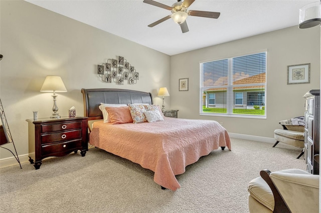 bedroom with a ceiling fan, baseboards, and carpet