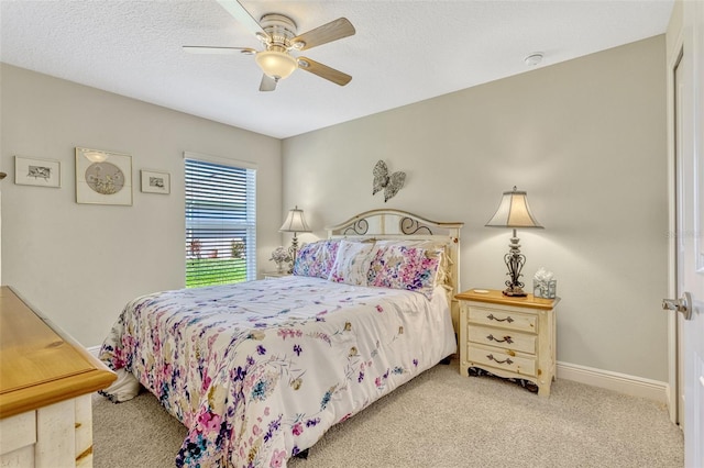 bedroom with a ceiling fan, baseboards, and light colored carpet