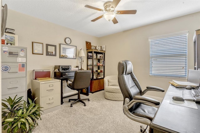 carpeted home office with ceiling fan