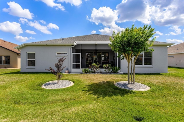 back of property featuring a lawn, stucco siding, and a sunroom