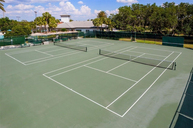 view of tennis court with fence and community basketball court