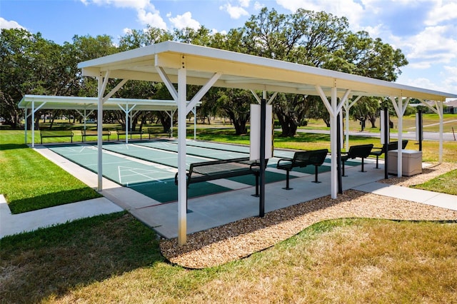 surrounding community with a yard and shuffleboard