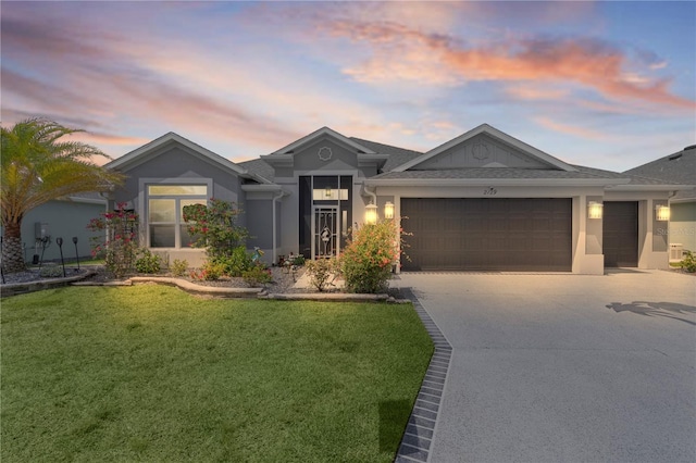 2129 Landrea Loop, The Villages, FL 32163 - view of front of house featuring concrete driveway, a yard, stucco siding, and a garage