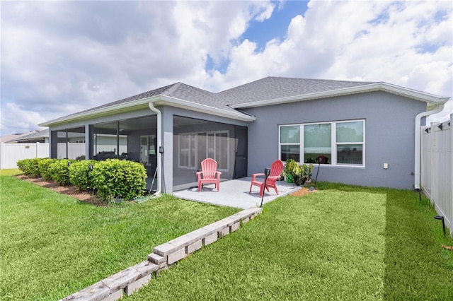 2129 Landrea Loop, The Villages, FL 32163 - back of house with fence, stucco siding, a sunroom, a patio, and a yard