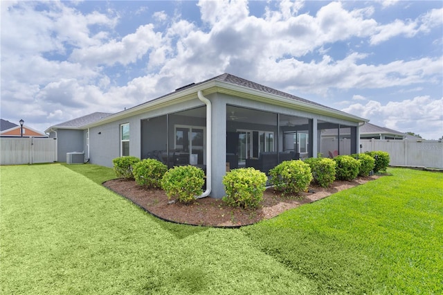 2129 Landrea Loop, The Villages, FL 32163 - rear view of house featuring a sunroom, a fenced backyard, a lawn, and cooling unit
