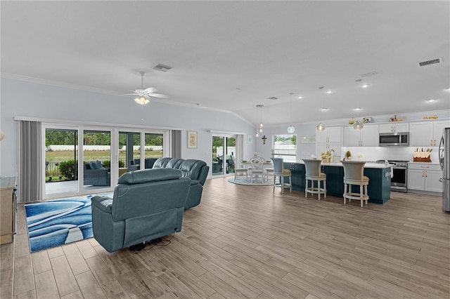 2129 Landrea Loop, The Villages, FL 32163 - living room with visible vents, ornamental molding, a ceiling fan, and light wood-type flooring