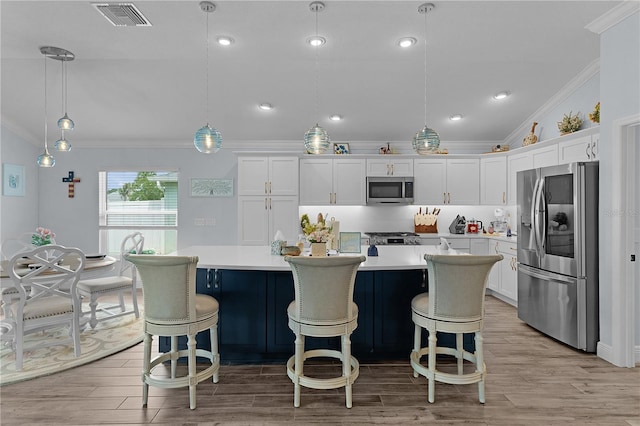 2129 Landrea Loop, The Villages, FL 32163 - kitchen with crown molding, appliances with stainless steel finishes, visible vents, and light countertops
