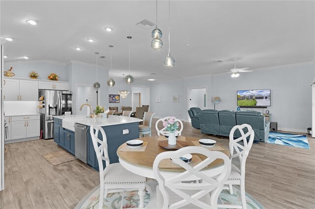 2129 Landrea Loop, The Villages, FL 32163 - dining space featuring visible vents, ornamental molding, light wood finished floors, and a ceiling fan