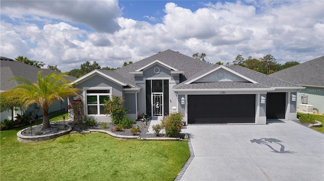 2129 Landrea Loop, The Villages, FL 32163 - ranch-style house with a shingled roof, an attached garage, stucco siding, a front yard, and driveway