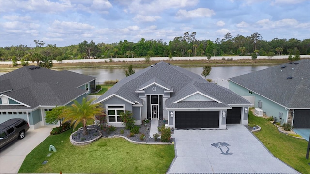 2129 Landrea Loop, The Villages, FL 32163 - single story home with a water view, an attached garage, driveway, and a front lawn